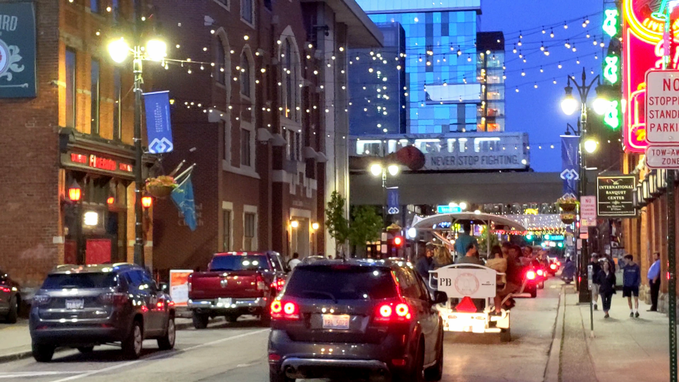 Detroit Rolling Pub, Monroe Street in Greektown, with People Mover overhead