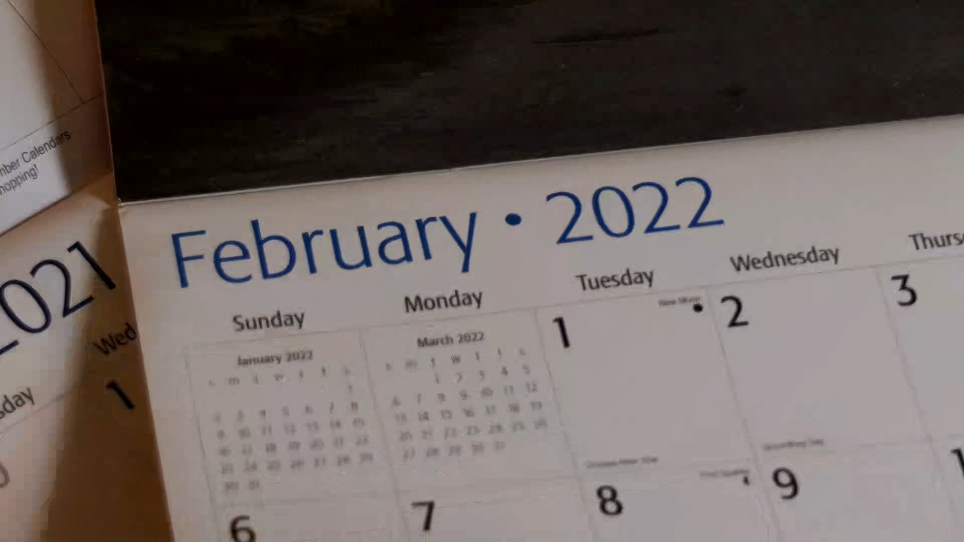 Flipping page by page through the months of a new 2022 calendar