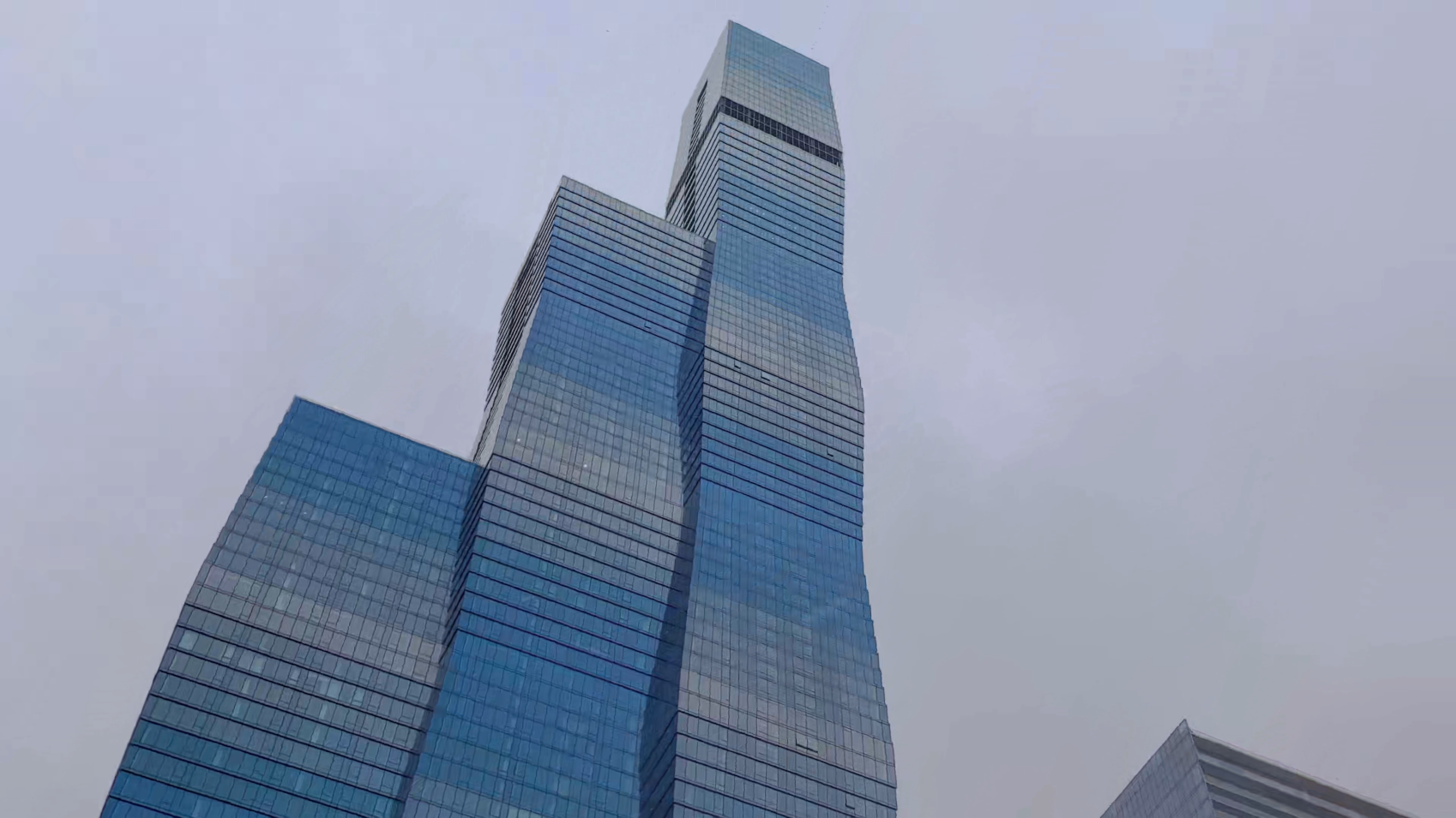 From Chicago River, tilt up to full height of blue St. Regis Chicago skyscraper